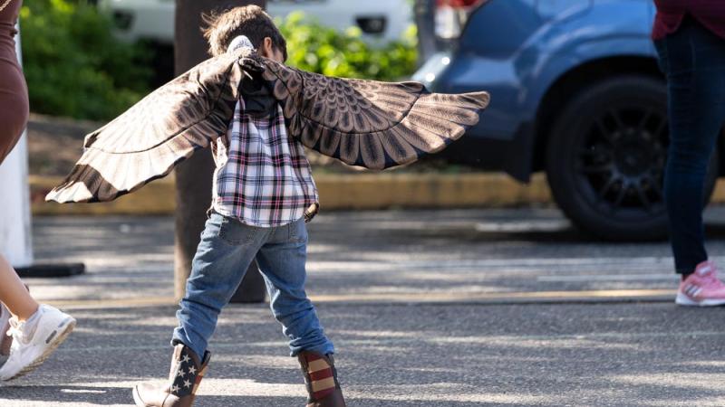 young boy dancing with wings