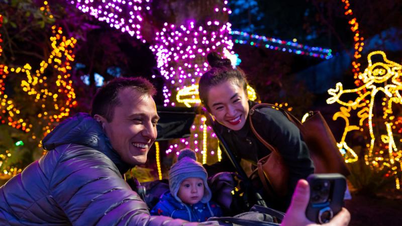 family taking selfie at Zoo Lights