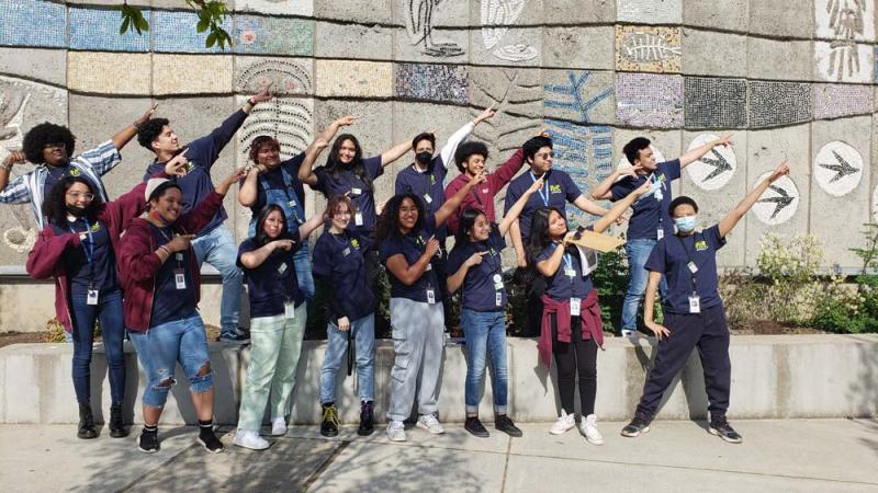 Zap youth dab dance pose in front of education center