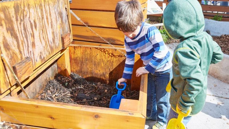 Children digging in the zoo wildlife garden. 