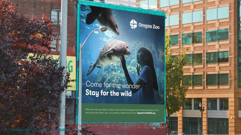 An Oregon Zoo billboard that says Come for the wonder, Stay for the wild