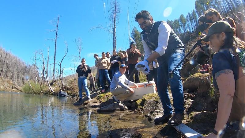 Metro Councilor Juan Carlos González holding a lamprey