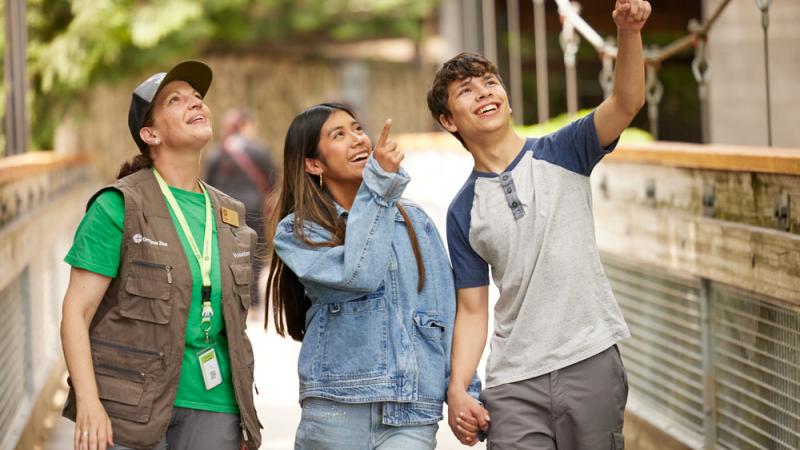 zoo volunteer interacting with guests on grounds