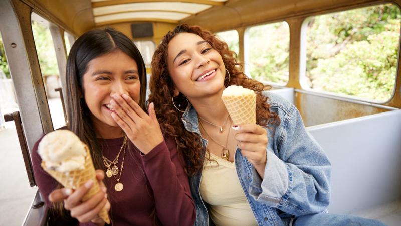 youth enjoying ice cream on zoo train
