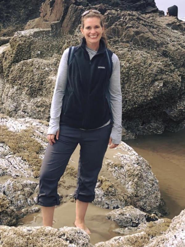 animal curator Kate Gilmore in a tide pool on the Oregon Coast