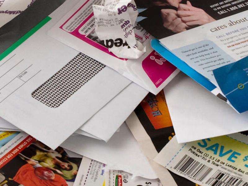 A pile of junk mail and coupons. 