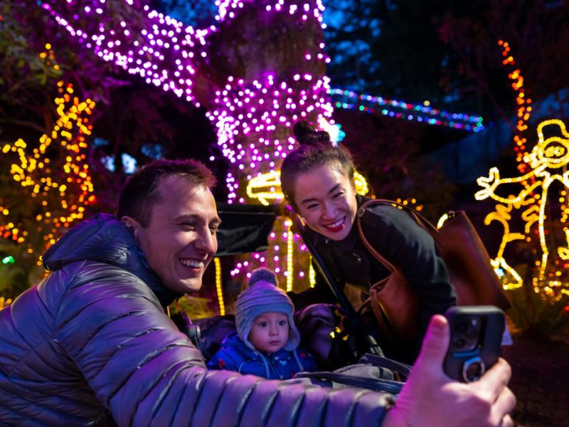 family taking selfie at Zoo Lights