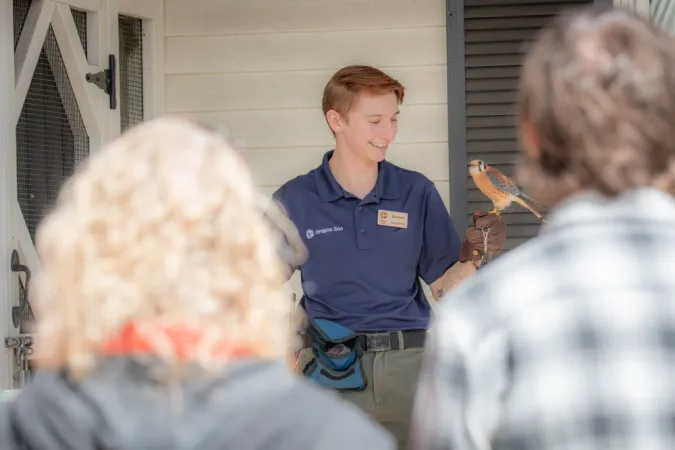 A keeper gives a chat featuring a bird.