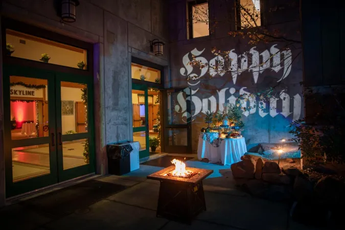 Patio at night with holiday lighting and buffet